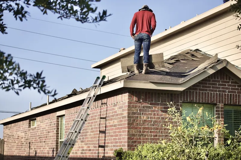 Professional roofer working on a residential roof in Saint Vladimirs